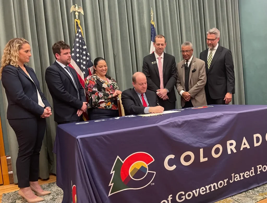 Gov. Jared Polis signs HOME Act, aimed at making it easier for nonprofits to build housing