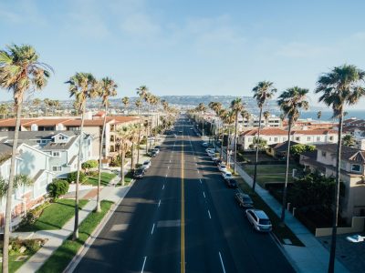 View of a residential street in Redondo Beach, CA. The ocean can be seen in the background.